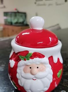 a santa clause cookie jar sitting on top of a counter