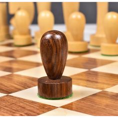 a chess board with wooden pieces on it and one piece in the middle of the board