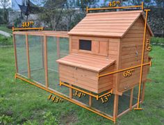 a wooden chicken coop in the grass