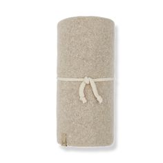 a roll of toilet paper with a white cord tied around the end on a white background