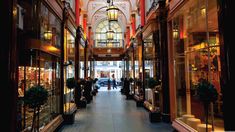 the inside of a building with people walking through it