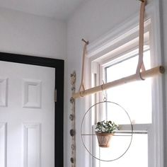 a white door with a plant on the window sill in front of it,