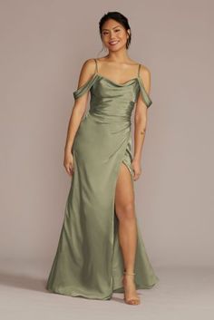 a woman in a green dress with one leg slited up and the other side split open