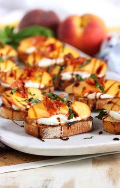 several pieces of bread on a plate with fruit in the background