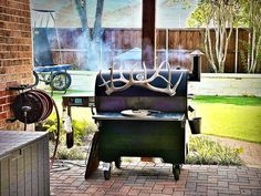 an outdoor bbq grill with antlers on it