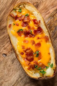 a baked potato with bacon and cheese on it