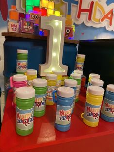 there are many different colors of paint on the table and one is for each child's first birthday