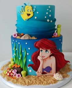 the little mermaid cake is decorated with fondant