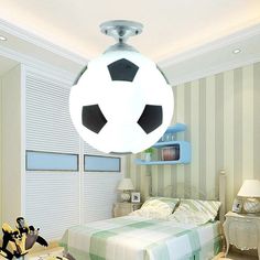 a bedroom with a soccer ball hanging from the ceiling