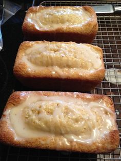 two pieces of bread covered in icing sitting on a cooling rack