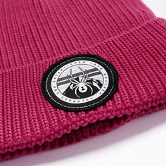 A custom Spyder logo patch adorns this simplistic polyester rolled cuff beanie which is at home on the playground or the ski mountain. Cotton Beanie With Logo Patch, Sporty Beanie For Outdoor, Sporty Outdoor Beanie Hat, Winter Cotton Beanie With Logo Patch, Winter Cotton Hats With Logo Patch, Winter Outdoor Beanie With Logo Patch, Casual Outdoor Hat With Custom Logo, Pink Outdoor Beanie Cap, Pink Beanie For Outdoor