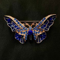 "This is a gorgeous gold brooch featuring a gold metal butterfly ornament, with blue enamel and dazzling blue AB faceted jewels that sparkle in the light. It's a really fun way to dress up any outfit, or as the something blue on your wedding day! 1 1/3\" long, and 2 1/4\" wide. Make sure to check out my shop for more hair pins, jewelry, accessories, and all sorts of fun stuff! Blue Butterfly, Jeweled Butterfly, Butterfly Brooch, Blue Enamel, Butterfly Pin, Sparkling Butterfly, Gold Butterfly, In Insect Brooch, Butterfly Insect, Enamel Butterfly, Butterfly Ornaments, Butterfly Butterfly, Metal Butterfly, Blue Fairy, Butterfly Pin, Head Jewelry