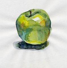 an apple sitting on top of a white sheet with green and yellow paint over it