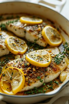 chicken with lemons and herbs in a pan