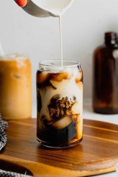 an iced drink in a mason jar on top of a cutting board with the words starbucks copycat vanilla sweet cream cold foam recipe