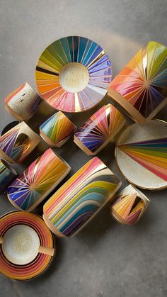 colorful plates and bowls are arranged on the floor