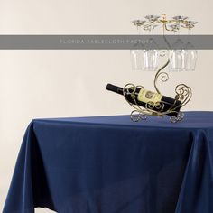 a table topped with a wine glass holder and a bottle of wine on top of it