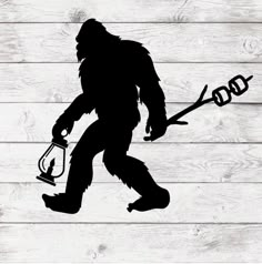 a silhouette of a bigfoot holding a lantern on a wooden planks background with the word god above it