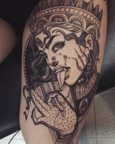 a woman's leg with tattoos on it