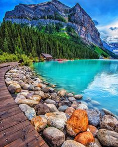 lake lousse, alberta canada with mountains in the background and rocks on the shore