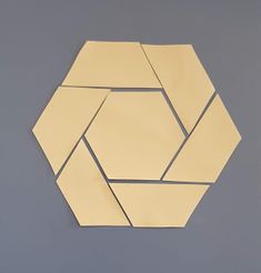 a piece of paper that has been cut into hexagons on the wall