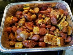 the food is prepared and ready to be cooked in the oven, including corn on the cob