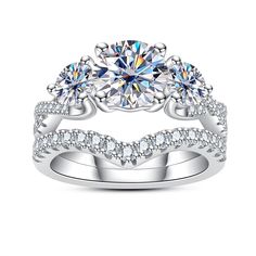 three stone wedding ring set with diamonds on each side and an accent band around the band