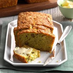 a loaf of banana bread on a plate with butter