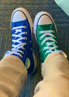 two people wearing blue and green converse shoes