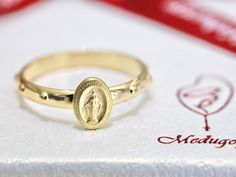 "Miraculous medal ring, rosary ring, 18 k gold plated sterling silver 925 ring, Our Lady rosary ring, Virgin Mary ring, dainty minimalist ring This rosary ring is made with sterling silver 925 and 18 k gold plated so it doesn't tarnish or change color. Ring itself is minimalist style with with 10 beads as rosary so it is one decade rosary and Miraculous Medal in middle. Miraculous Medal is made with coin technology so it is very clear written : \"O Mary, conceived without sin, pray for us who ha Miraculous Medal Ring, Rosary Ring Gold, Catholic Rings For Women, Virgin Mary Ring, Rosary Ring, Signet Rings Women, Decade Rosary, 925 Ring, Miraculous Medal