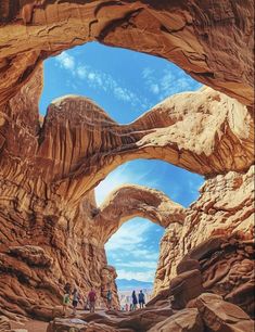 some people are walking through an arch in the desert