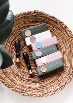 three different types of lipstick sitting on top of a wicker basket