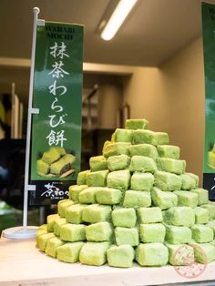 a pile of green cake sitting on top of a counter