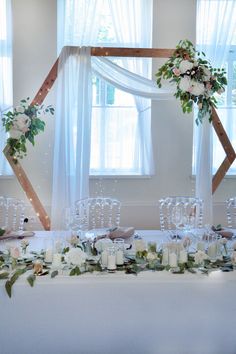 the table is set with candles, flowers and greenery for an elegant wedding reception