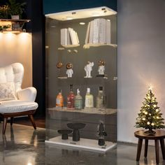 a christmas tree is sitting in front of a display case