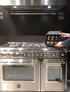 a man is checking the temperature on an oven