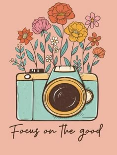 a camera with flowers on it and the words focus on the good