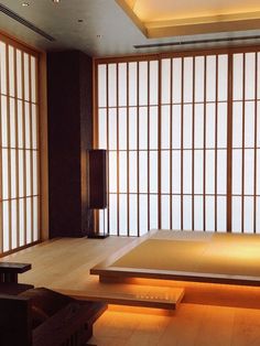 an empty room with tatami mats and lights on the floor in front of it