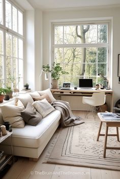 a living room filled with furniture and lots of windows