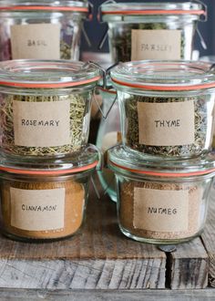 jars filled with spices labeled rosemary and thyme