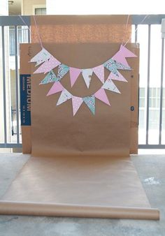 a brown bag with pink and blue decorations on it sitting in front of a gate