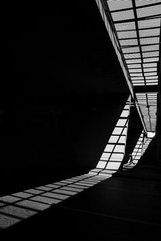 the shadow of a person walking in an empty building