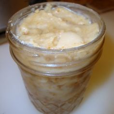 a glass jar filled with food sitting on top of a table