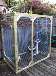 an outdoor toilet in the middle of a yard with a fence around it and potted plants