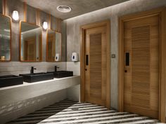 a bathroom with two sinks, mirrors and wooden shutters on the doors in front of them