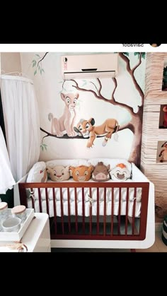 a baby's room with a crib and pictures on the wall, including animals