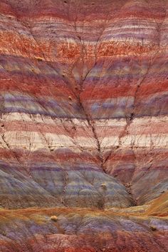 the colorful rock formations are painted with different colors and shapes, including red, purple, blue, green, and yellow