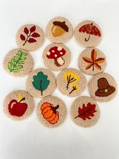 small knitted coasters with autumn designs on them