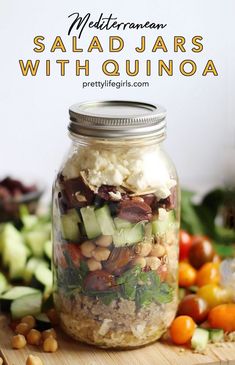 salad jars with quinoa, cucumber and tomatoes on a cutting board