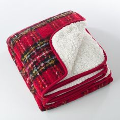 red and white blanket folded on top of each other